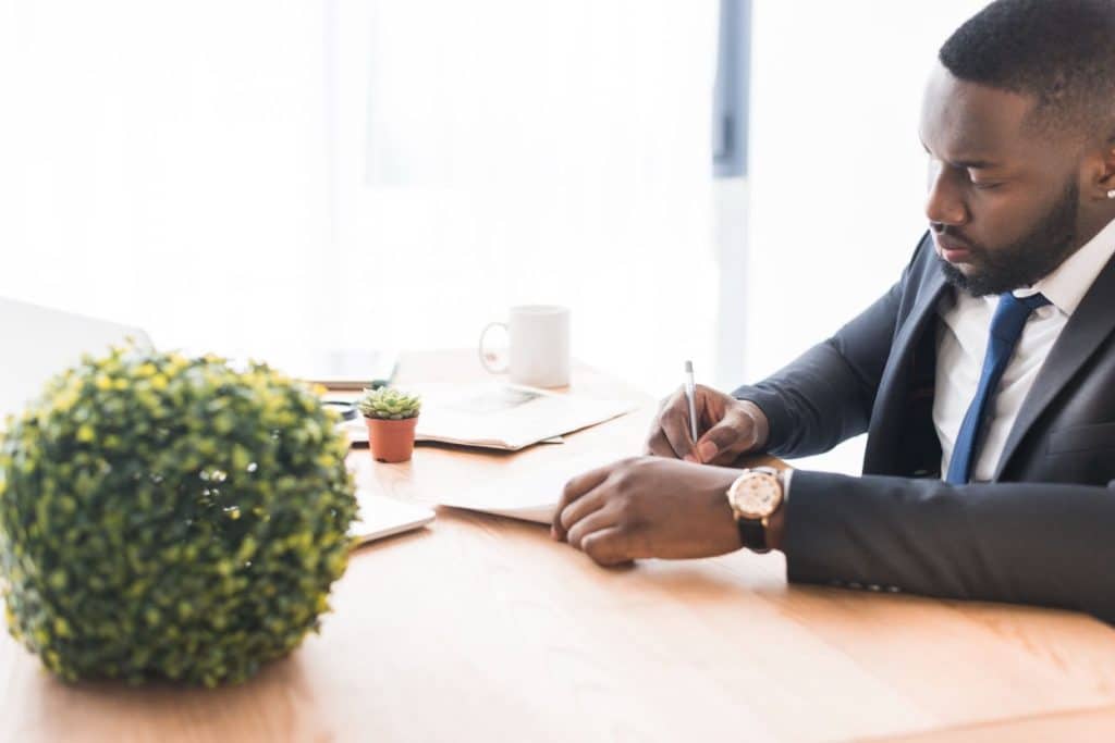 Debt Collection Documents: What Is Needed & Why It Matters 4 A business professional signing a contract document.