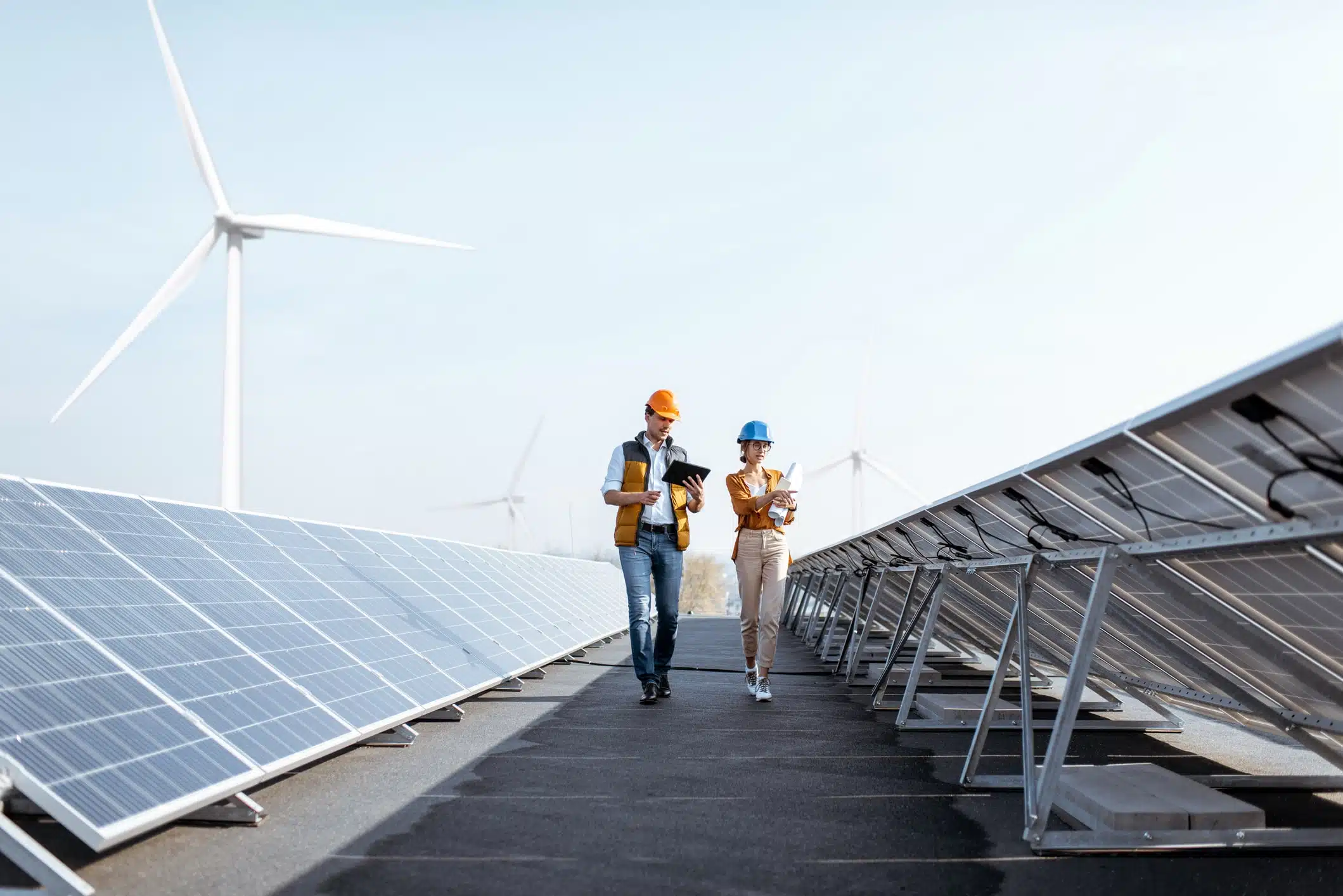 Utility Debt Collections 1 utility workers walking between solar panels