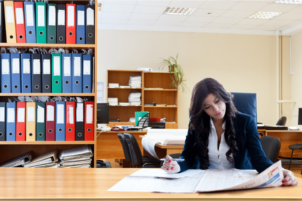 Collection Agency vs Small Claims Court: Differences, Pros & Cons 6 Business owner analyzing financial documents and comparing options on desk