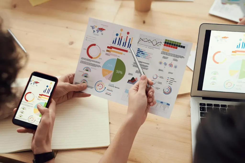 Debt Collection Agency in Dallas: Reviews, Benefits & Best Companies 5 Business professional reviewing charts on printed reports