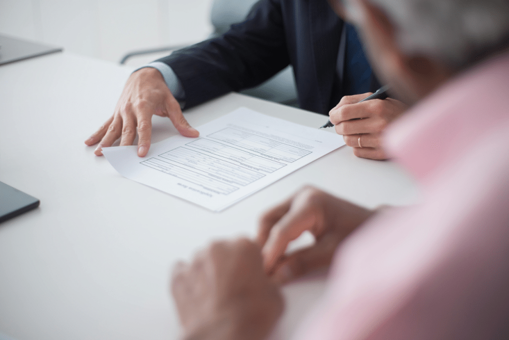 Commercial vs Consumer Collections: Differences & Examples 3 Business professionals reviewing financial documents