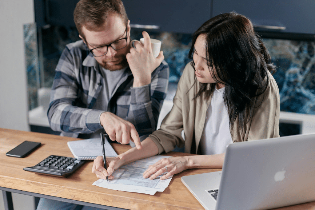 Debt Collection Agency in St. Louis, MO: Cost, Benefits & Best Companies 5 Two business professionals reviewing financial documents