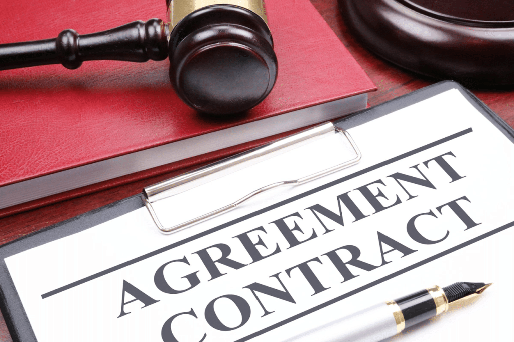 How to Hire a Collection Agency: Tips for Businesses 4 Agreement contract document with gavel and pen