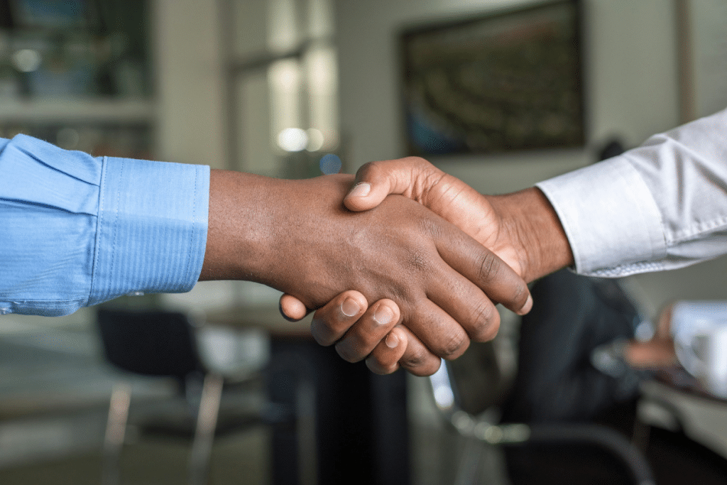Sending an Account to Collections: Cost & Requirements Explained 4 Two business professionals shaking hands in an office setting