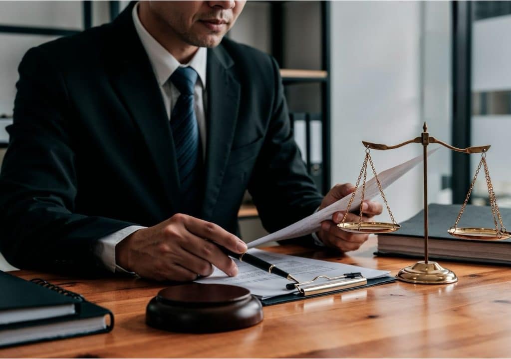 How to File a Debt Collection Lawsuit: Options Explained 3 Judge reviewing case documents.