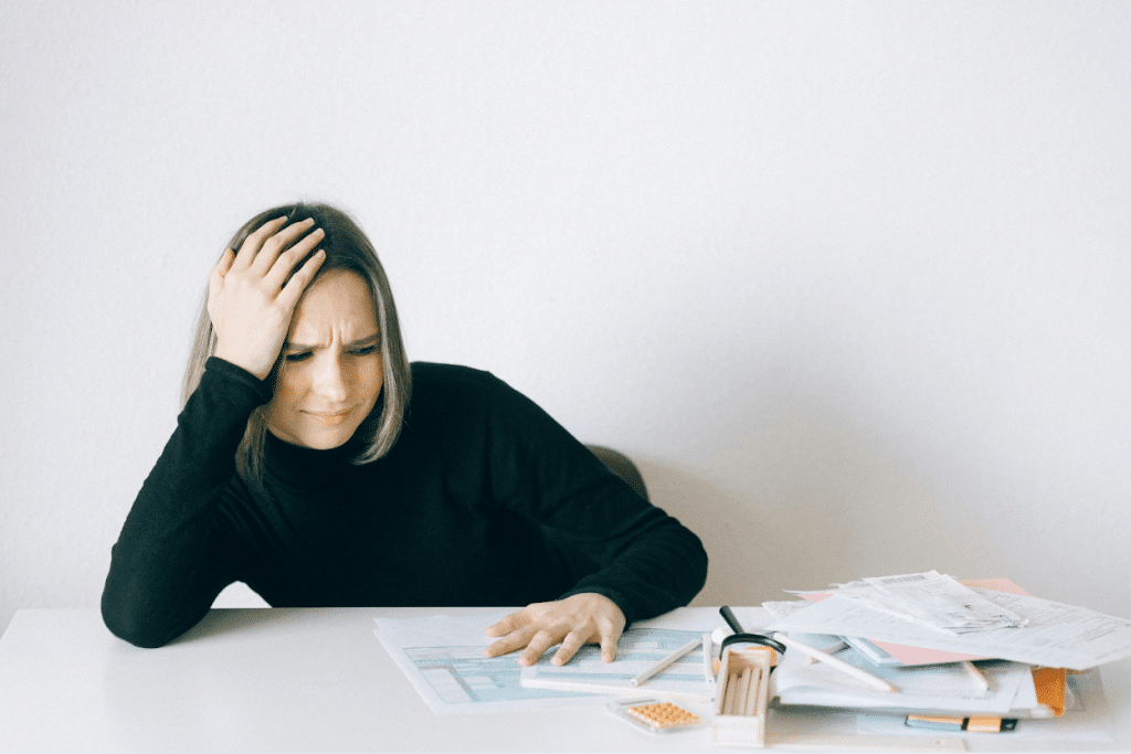 Debt Collection Agency in The Woodlands, TX: Top Companies, Price & Reviews 3 Woman reviewing bills and documents at a table