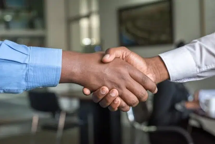 Collection Agency in Abilene, TX: Cost, Reviews & Best Companies 3 Close-up of two professionals shaking hands in an office setting