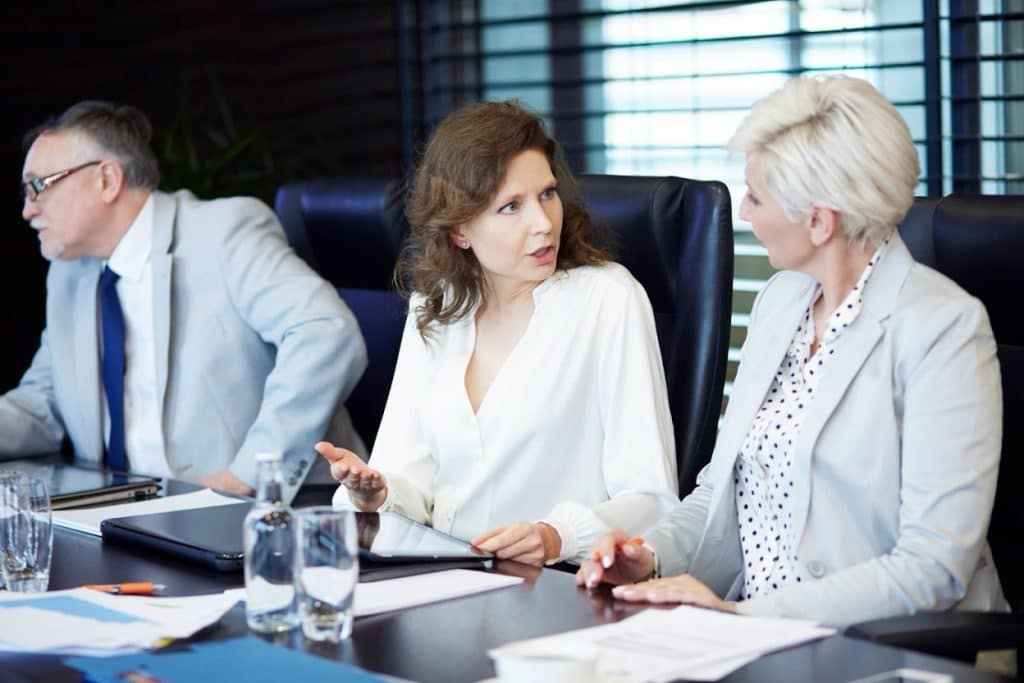 Commercial Collection Agency in Allen, TX: Price, Reviews & Best Companies 4 Business professionals reviewing documents and discussing at a table