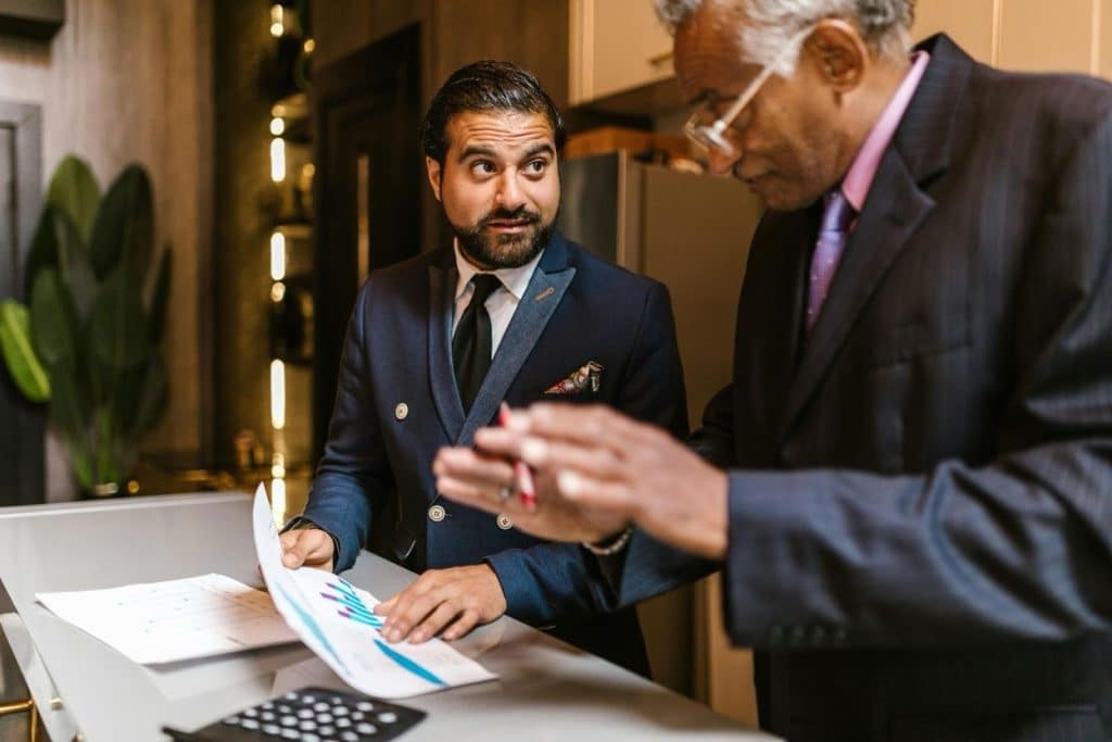 Collection Agency in Hurst, TX: Best Companies, Price & Reviews 6 Business professionals reviewing financial pricing documents