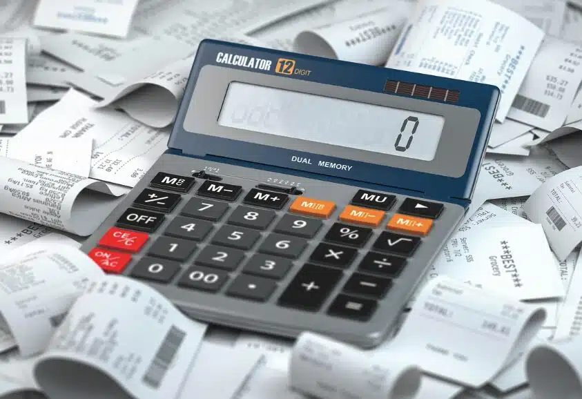 Data Center Payment Delays: Financing, Disputes & Debt Collection Options 3 A calculator lying next to a bunch of payment receipts, signifying billing calculations