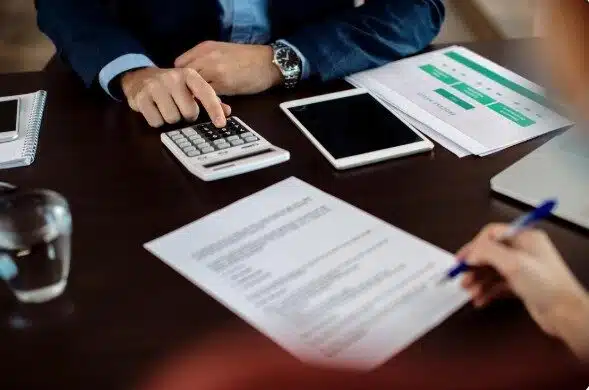 3 Best Collection Agencies in Canton, OH: Price & Client Feedback 7 Two professionals reviewing accounts receivable documents during a commercial debt recovery discussion
